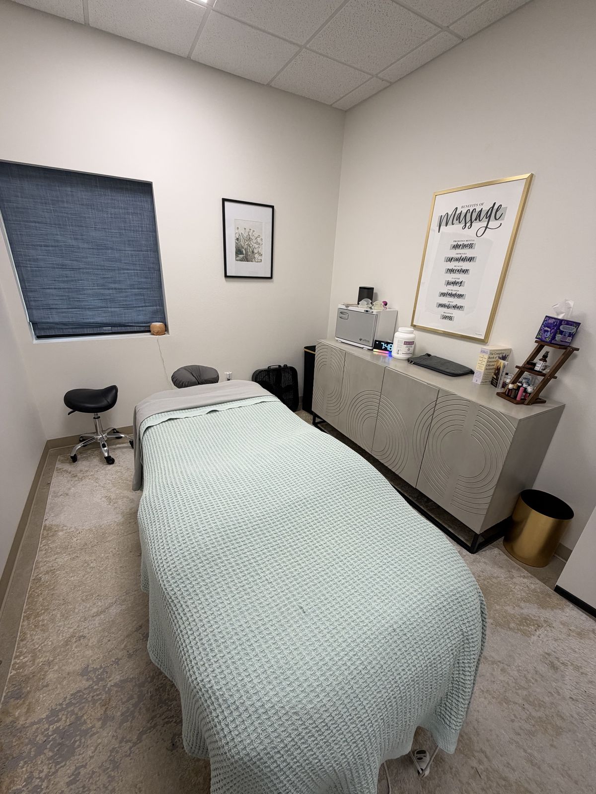 A bright Vitality massage therapy room with an adjusting table